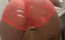 tattooed girl in orange fishnet lingerie twerking bent over